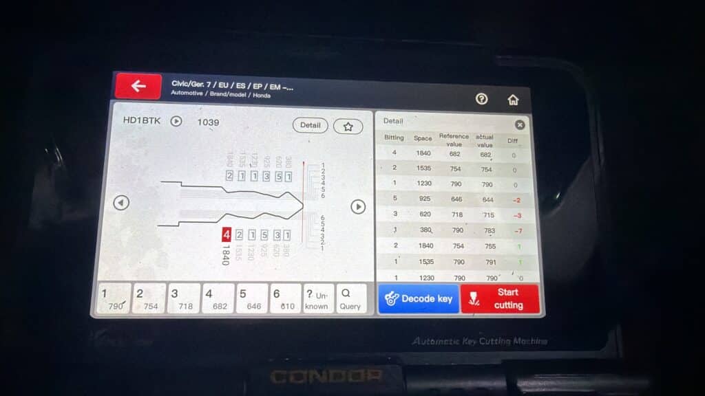 Condor automotive key cutting machine displaying Honda Civic key cutting data during a locksmith job in West Falls Church, VA.