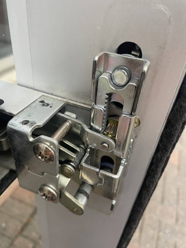 Exposed commercial door locking mechanism and metal hardware on a door on Carol Lane in West Falls Church, VA.